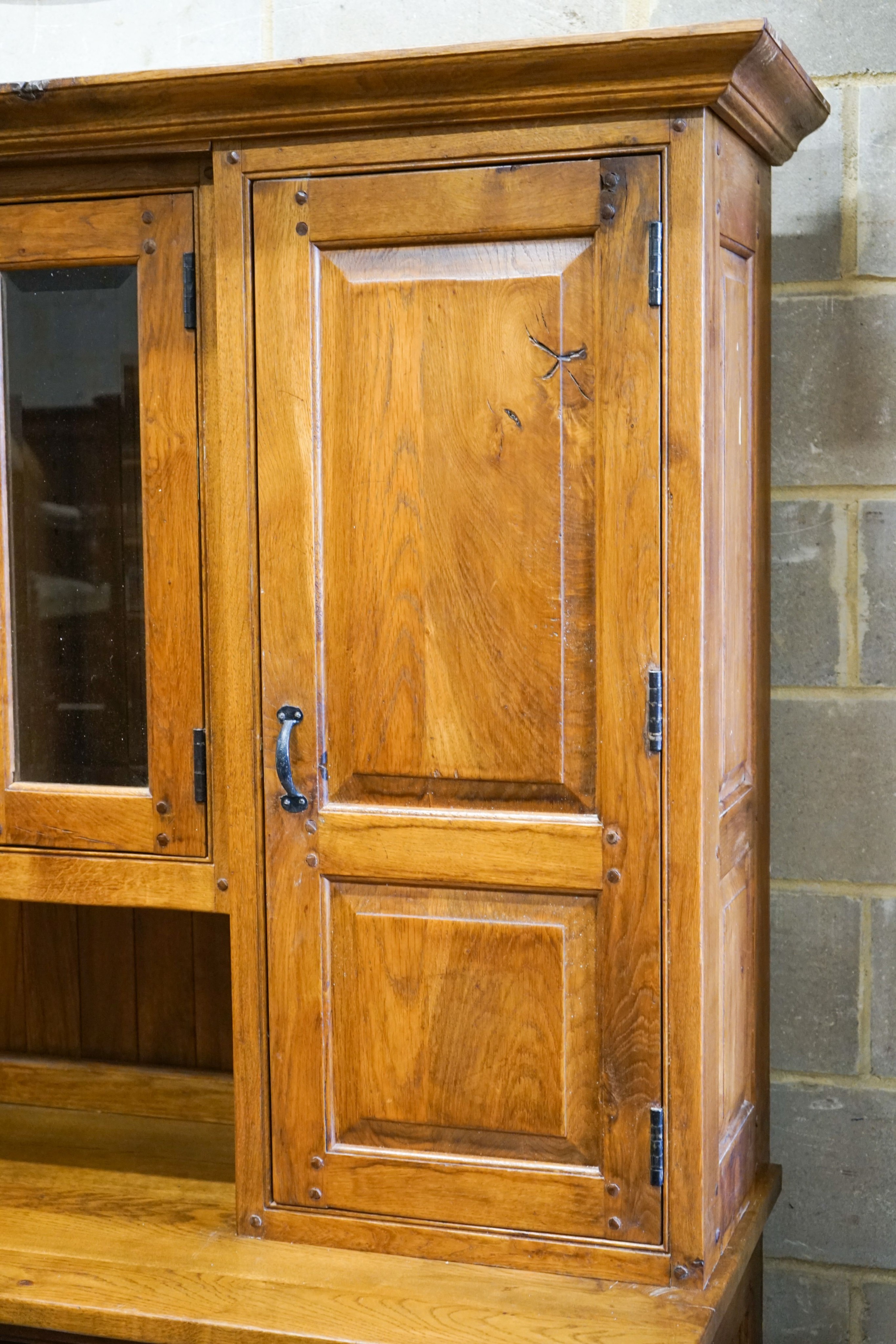 A large reproduction oak dresser with wine bottle storage, length 244cm, depth 60cm, height 201cm